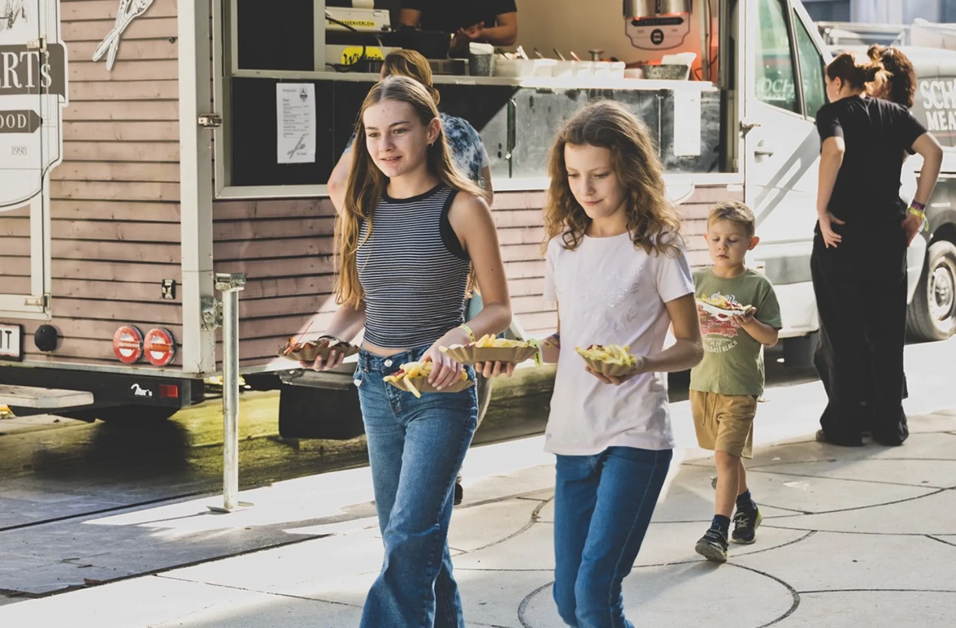 Zwei Mädchen holen sich etwas zu essen von den Foodtrucks beim Schaffarei Festival 2025
