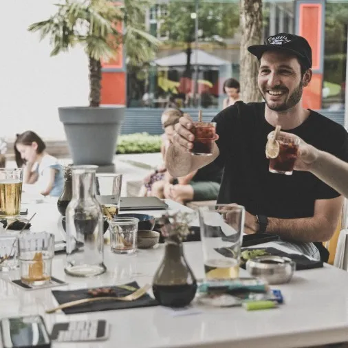 Terasse Lokal Hunger und Durst sich zuprostende glückliche Menschen